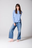 Chambray Blue Cashmere Sweatshirt, styled with jeans front view. 